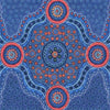 A close-up of a blue patterned fabric  featuring a central circular mandala design with coral, blue and yellow dots on a blue background