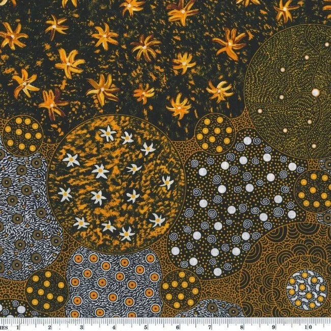 Wid Bush Tomato Gold australian fabric by Christine Doolan is a striking design in tans, gold, black and greys featuring flowers and lots of interconnected circles filled with different dot-based patterns. 