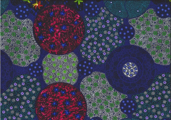 Wild Bush Tomato Multi Australian fabric by Christine Doolan is a striking design in luminous royal blue, green, red, white and navy featuring flowers and lots of interconnected circles filled with different dot-based patterns. 