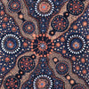 A close-up of a patterned textile featuring a dark navy blue background with intricate Aboriginal-style dot art motifs in terracotta orange, beige, white, and small blue accents.