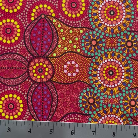 Campsite red is a striking design in vibrant shades of red, green and yellow with white circle accents by Aboriginal Artist Bernadine Wallace.