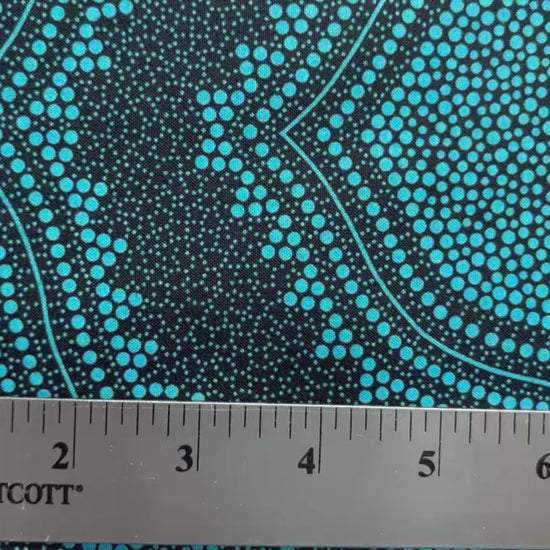 In this fabric, softly contrasting shades of sky blue, turquoise, black and white accents&nbsp;form patterns representing wind-scattered seeds and spinifex grasses—elements deeply rooted in desert life and culture.