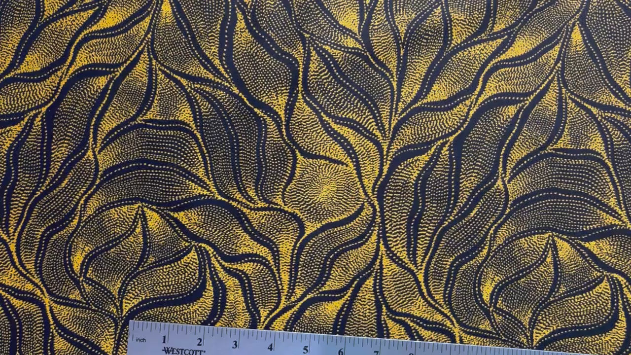 Sandhill and Waterhole Gold&nbsp;is a striking design by Aboriginal artist Anna Pitjara, featuring intricate golden yellow motifs on a deep black background.