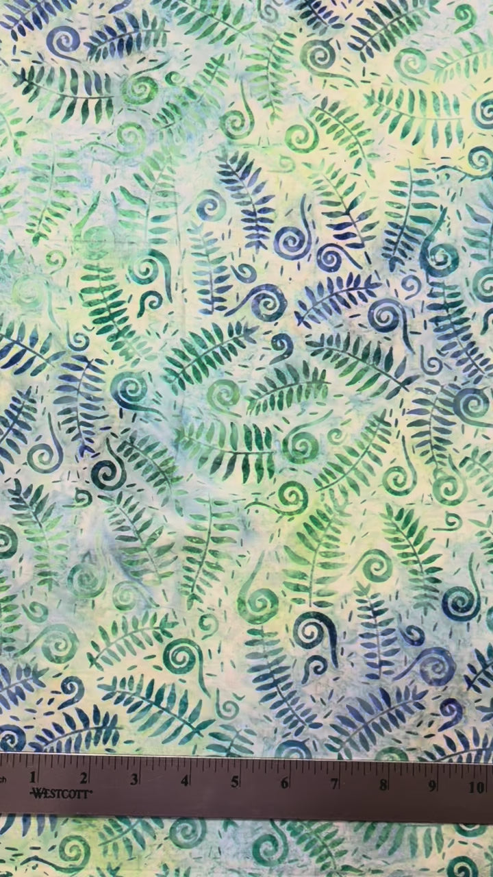 blue and green fern leaves and fiddlehead fabric with a ruler on the top