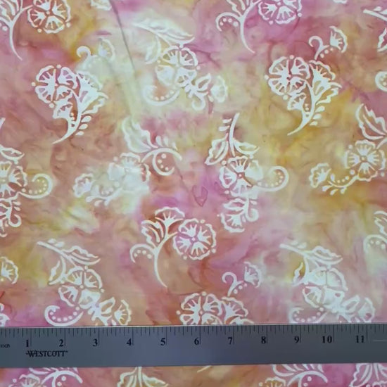 delicate cream flowers floating on pink and peach background