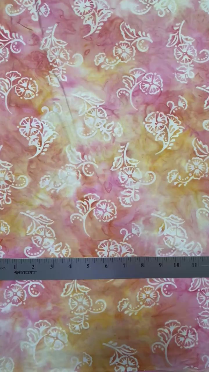delicate cream flowers floating on pink and peach background