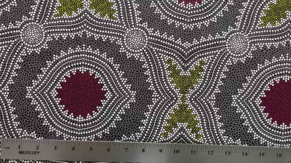 In this fabric, softly contrasting shades of grey, olive, burgundy, and white form patterns representing wind-scattered seeds and spinifex grasses—elements deeply rooted in desert life and culture.