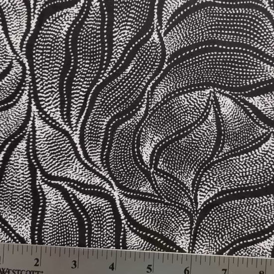 Sandhill and Waterhole Black&nbsp;is a striking design by Aboriginal artist Anna Pitjara, featuring intricate white motifs on a deep black background.