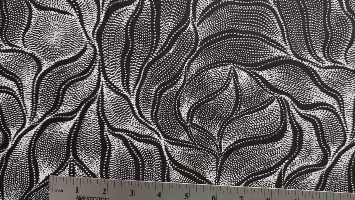 Sandhill and Waterhole Black&nbsp;is a striking design by Aboriginal artist Anna Pitjara, featuring intricate white motifs on a deep black background.