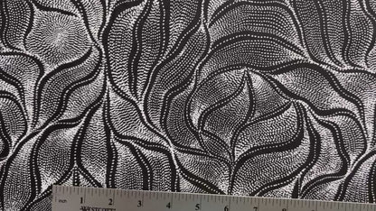 Sandhill and Waterhole Black&nbsp;is a striking design by Aboriginal artist Anna Pitjara, featuring intricate white motifs on a deep black background.