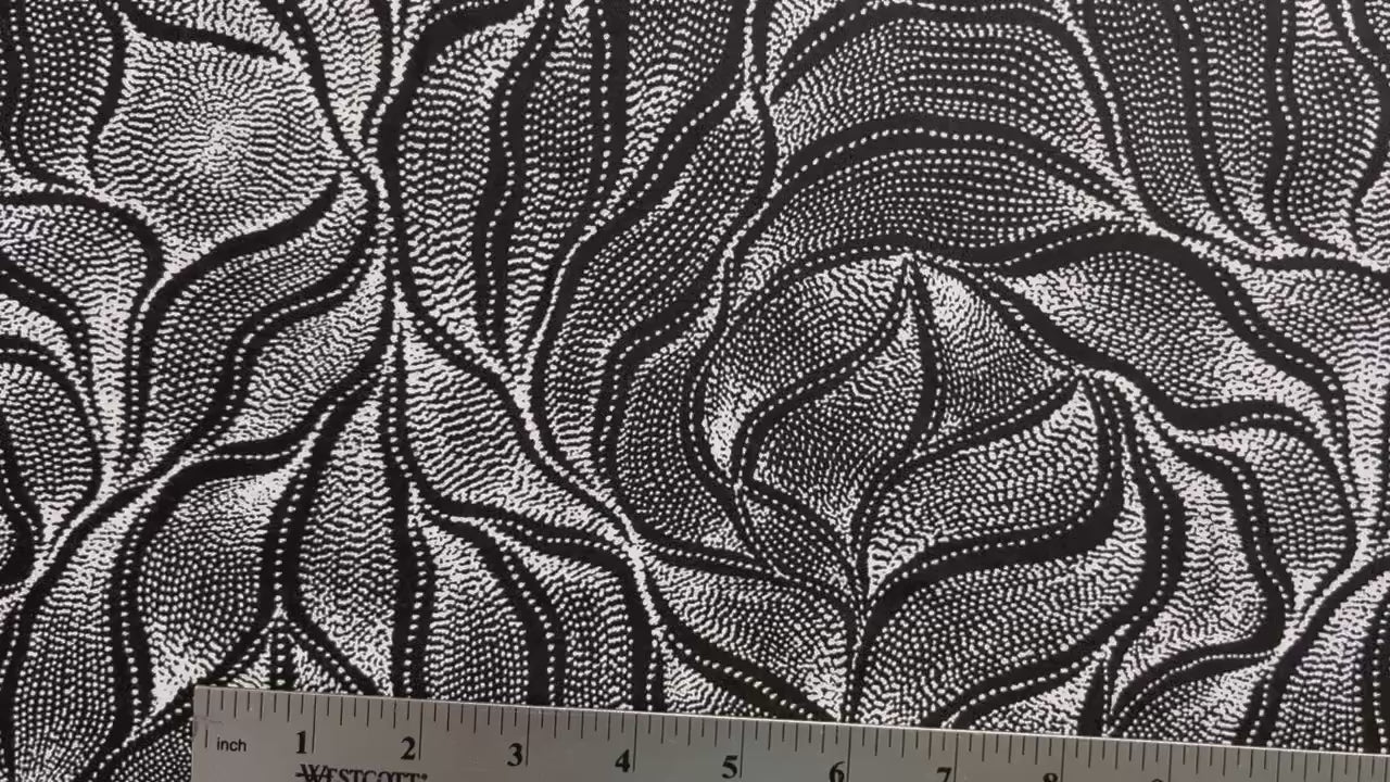 Sandhill and Waterhole Black&nbsp;is a striking design by Aboriginal artist Anna Pitjara, featuring intricate white motifs on a deep black background.