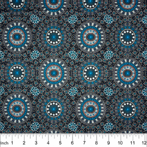 Alura Seed Dreaming Blue Australian aboriginal fabric by Karen Bird depicts the Alura seeds arranged in circles, with decorations around them in peach and white and grey, printed with a black background