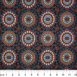 Alura Seed Dreaming Red Australian Aboriginal Fabric by Karen Bird depicts the Alura seeds arranged in circles, with decorations in tan, purple and white surrounding it. The design is printed on a black background