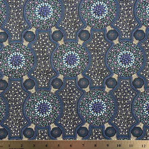 Bush Flowers blue  Australian Aboriginal fabric is an intricate design depicting flowering bushes in rich shades of blues, periwinkles and white on a black background.