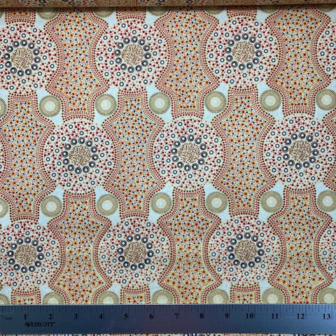 Bush Flowers  ecru Australian Aboriginal fabric is an intricate design depicting flowering bushes in vivid shades of orange, red, tan and yellow on an ecru background.