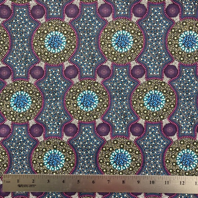 Bush Flowers  purple Australian Aboriginal fabric is an intricate design depicting flowering bushes in rich shades of purples, lavenders and olive on a black background.