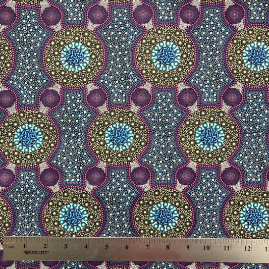 Bush Flowers  purple Australian Aboriginal fabric is an intricate design depicting flowering bushes in rich shades of purples, lavenders and olive on a black background.