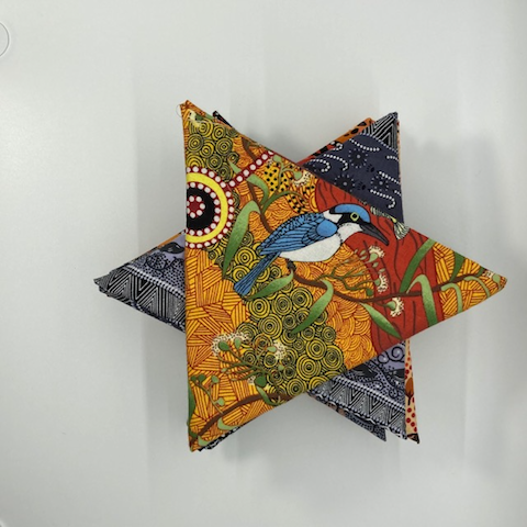 This picture shows a lovely collection of Australian Aboriginal cotton fabrics depicting the wildlife in Australia, shown in a 12 Fat Quarter bundle that was carefully curated