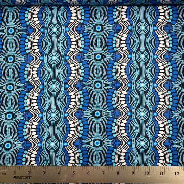Desert Flora Blue Australian Aboriginal fabric by Roseanne Ellis for M&S Textiles is a vibrant design in striking shades of turquoise, blue and white on a black background.
