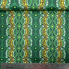 Desert Flora green Australian Aboriginal fabric by Roseanne Ellis for M&S Textiles is a striking design in vibrant shades of lime, green and olive on a black background.