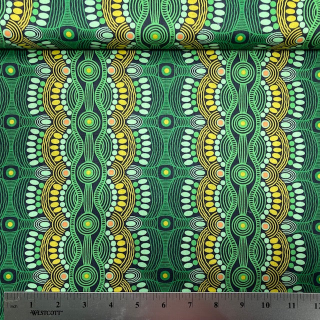 Desert Flora green Australian Aboriginal fabric by Roseanne Ellis for M&S Textiles is a striking design in vibrant shades of lime, green and olive on a black background.