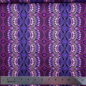 Desert Flora purple Australian Aboriginal fabric by Roseanne Ellis for M&S Textiles is a striking design in vibrant shades of hot pink and purples on a black background.