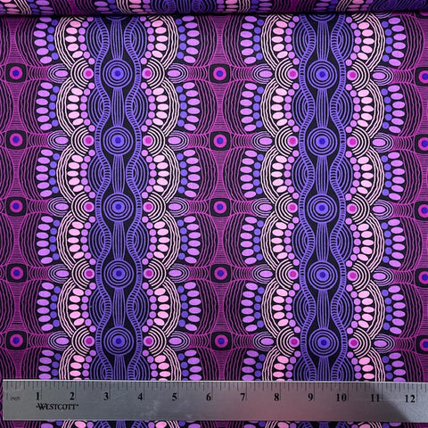 Desert Flora purple Australian Aboriginal fabric by Roseanne Ellis for M&S Textiles is a striking design in vibrant shades of hot pink and purples on a black background.