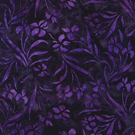 Indonesian artists created this lovely hand painted Batik fabric with a glowing purple flower design on a dark dark purple background.