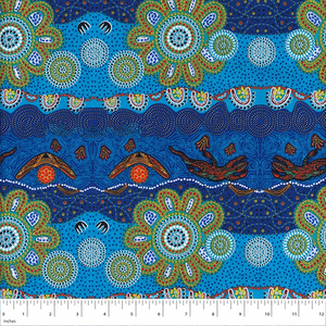Home Country Blue Australian Aboriginal fabric is a delightful design in brilliant shades of blue and turquoise, depicting flowers, boomerangs and goannas.