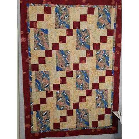 It's a snap Quilt pattern made from Australian Aboriginal fabrics in blues and reds, with an Indonesian Batik in yello