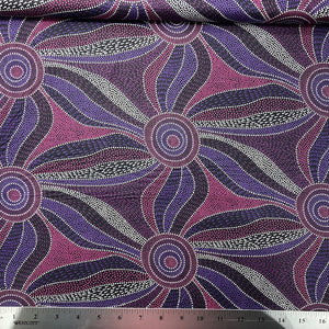 Ladies Dancing with Water Paints  purple Australian Aboriginal fabric is a large scale flowing design in fuchsia, purples and white on a black background.