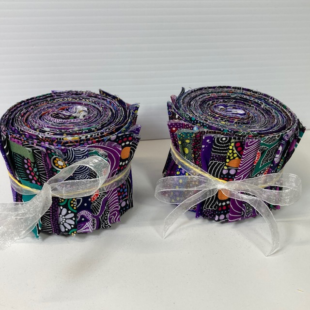 The Dreamtime Rolls of 20 purple Australian Aboriginal Fabric strips (2.5" wide, 42" long) are composed of 20 different prints, one strip of each. 
