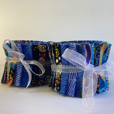 The Dreamtime Rolls of 20 blue Australian Aboriginal Fabric strips (2.5" wide, 42" long) are composed of 20 different prints, one strip of each. 