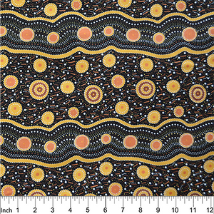 Wild Beans Gold Australian Aboriginal Fabric depicts women collecting wild beans in gold and orange on a black and rust background