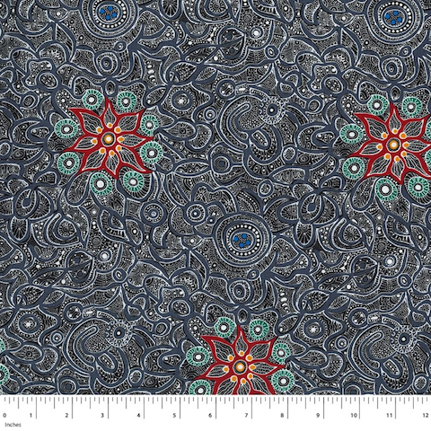 Yallaroo black Australian Aboriginal fabric depicts a field of flowers in soft greys on a black background with green and orange flowers strewn in. 